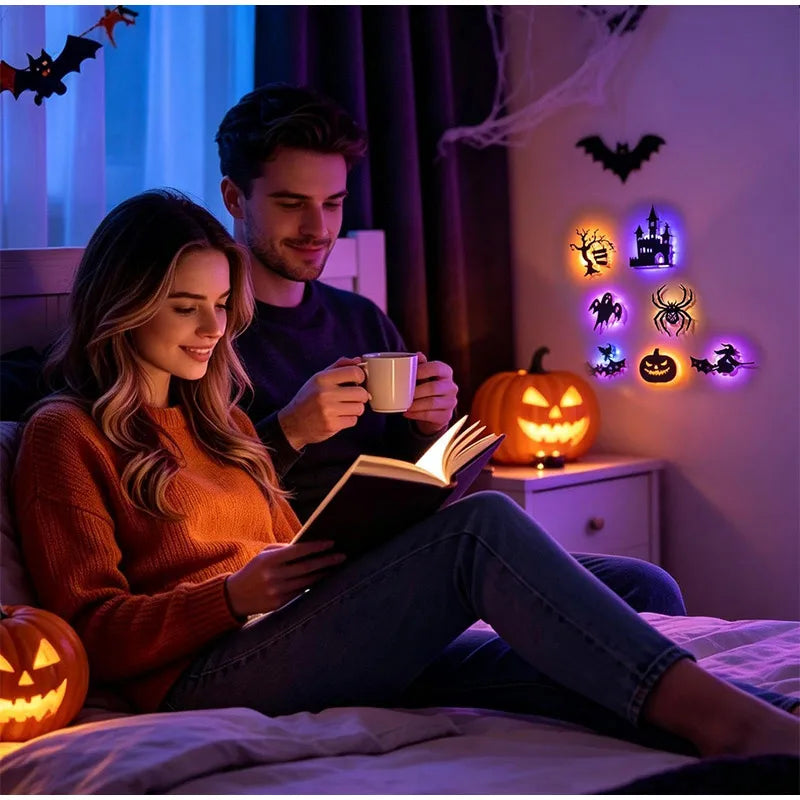 A woman and a man relaxing in bed reading under purple Halloween themed LED night lights on the wall.