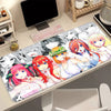 A desk mat featuring illustrations of the Quintessential Quintuplets anime characters with a non-slip rubber base.