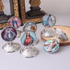 A collection of vintage silver-framed Catholic tabletop ornaments featuring religious figures like Jesus and Mary.