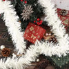 A festive holiday decoration featuring a white tinsel ribbon garland wrapped around a green fir branch with red berries and p