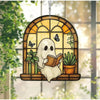 A Halloween ghost figure with a book is displayed in a stained glass window frame decorated with plants and butterflies.