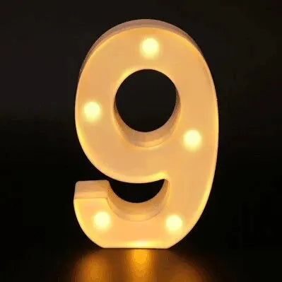 A luminous LED alphabet night light shaped like the number 9, glowing warm white.