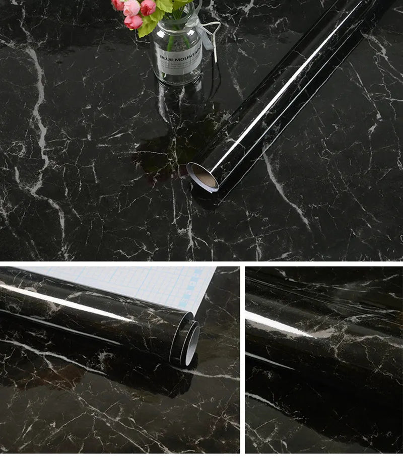A silver metal rod with a marble finish is displayed on a black marble surface next to a glass jar of flowers.