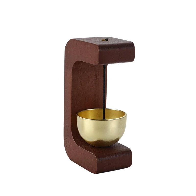 A wooden doorbell featuring a magnetic mechanism and a brass chime bowl.