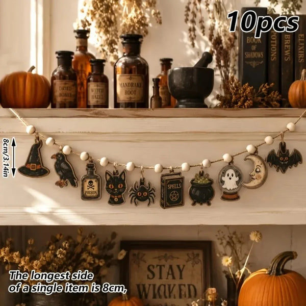Vintage Halloween wooden hanging garland featuring retro pumpkin, ghost, and cat beads on a white shelf.