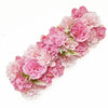 A lush pink artificial rose flower arch panel featuring various shades of pink and light green foliage.