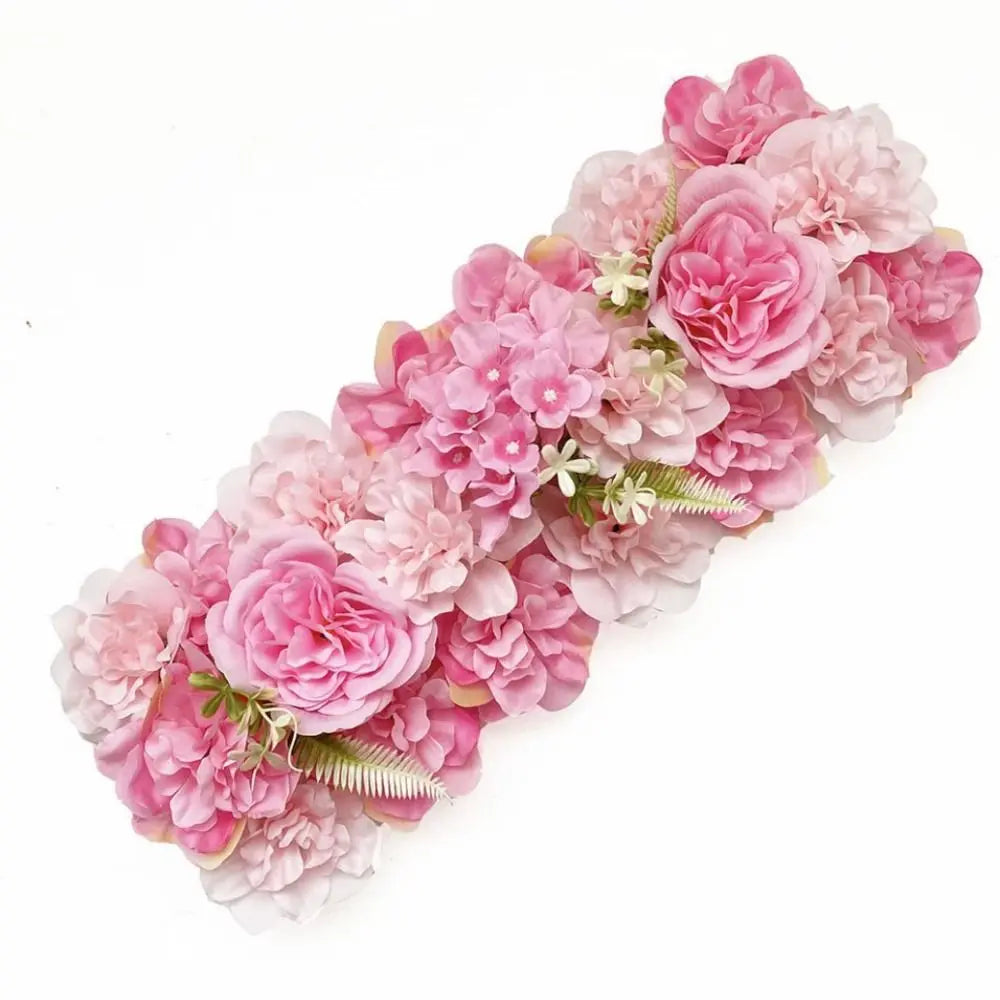 A lush pink artificial rose flower arch panel featuring various shades of pink and light green foliage.