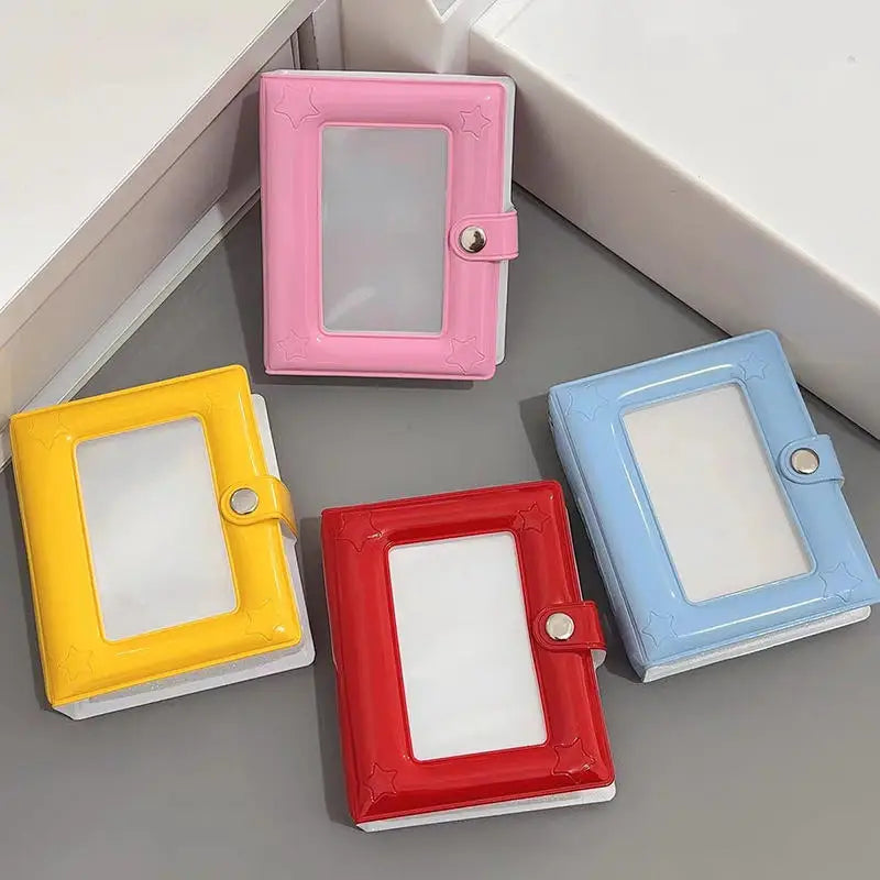 A collection of colorful mini photo card binders in pink, yellow, blue, and red.