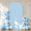 A light blue arched backdrop decorated with white and light blue balloons and silver glitter