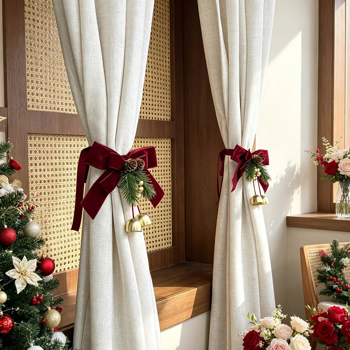 Festive Christmas curtain tie-backs with red bows and pinecones hanging in a wooden window frame.