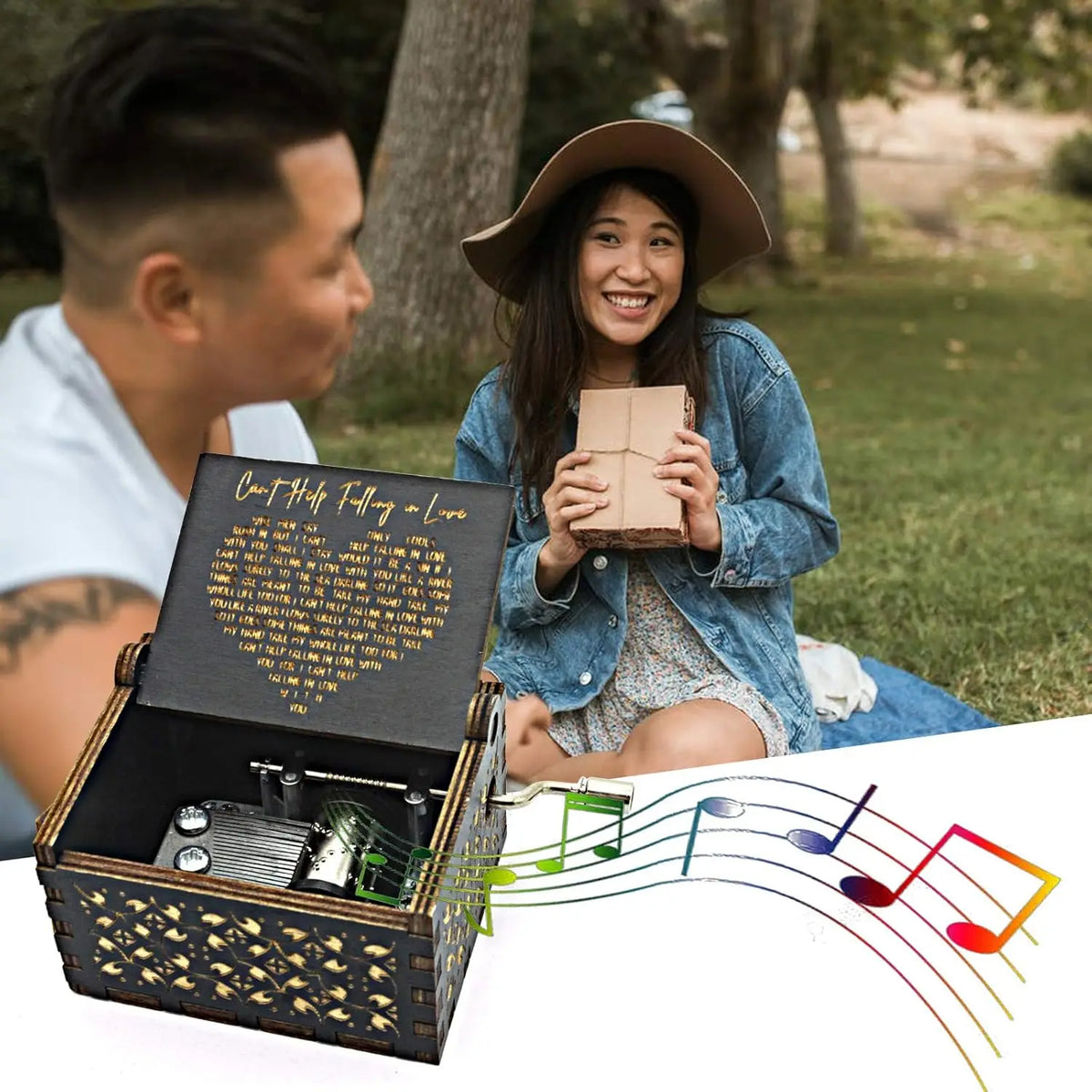 A young woman smiles while holding an open wooden music box with antique engraving and musical notes flowing from it.