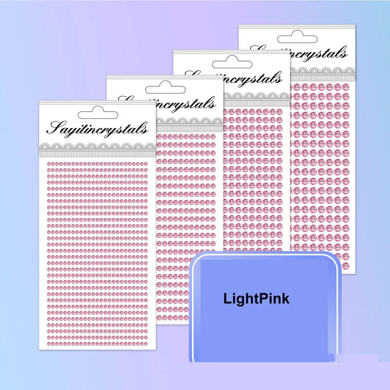 A collection of pink and clear self-adhesive rhinestone embellishments in various sizes and shapes.