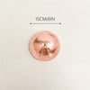 A round, rose gold disco ball with a textured surface, measuring 15cm/6in.