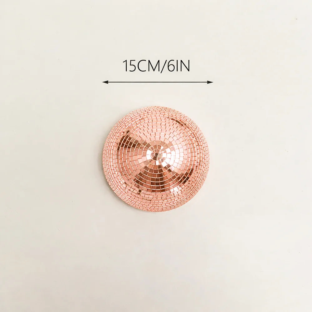 A round, rose gold disco ball with a textured surface, measuring 15cm/6in.