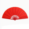 Red plastic fan with durable ribs used for Tai Chi performance.