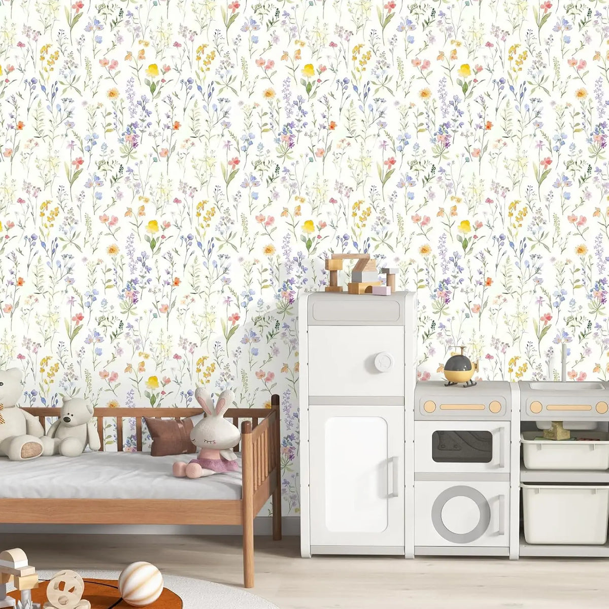 A white wooden bed is set against a wall covered in boho floral peel and stick wallpaper.