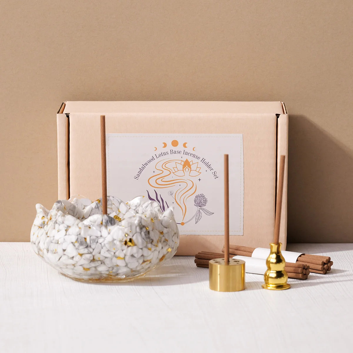 A set of sandalwood lotus base incense holders and natural crystal droppers displayed on a light wooden surface.
