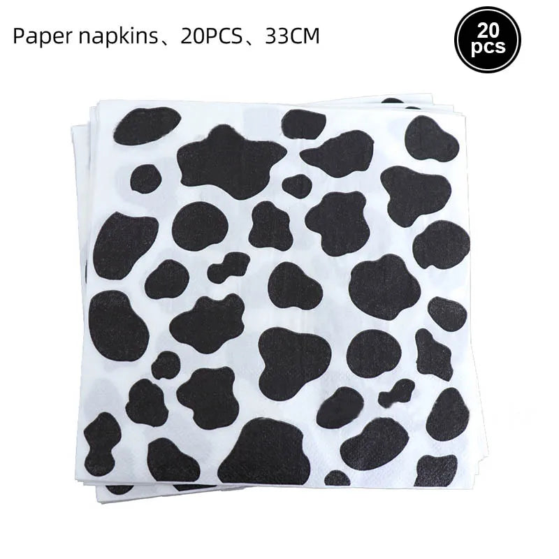 A stack of 20 black and white cow print paper napkins.