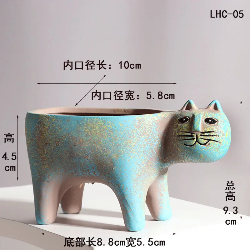 A light blue ceramic cat planter with a long opening, showing dimensions for indoor plant use.