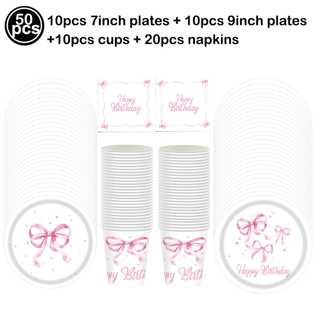 A set of pink bow disposable party tableware including 7 inch and 9 inch plates, cups, and napkins.