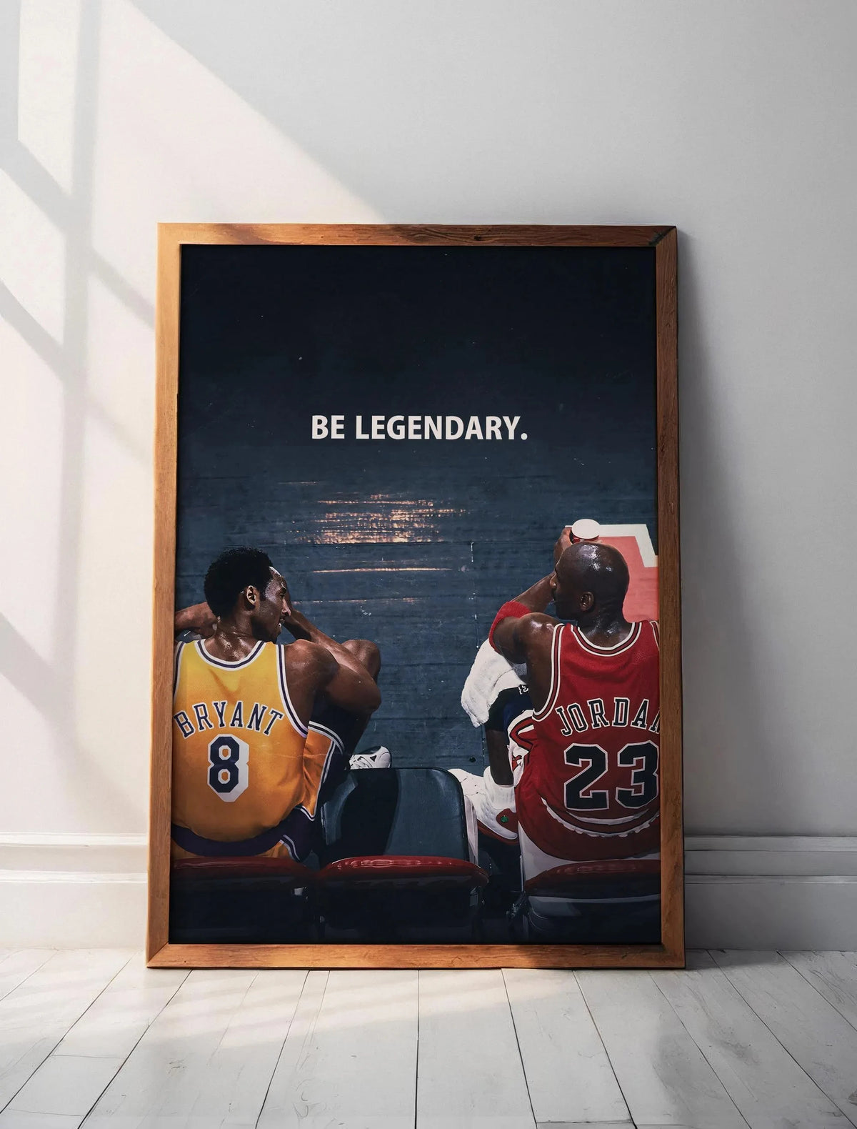 A framed canvas wall art featuring a photograph of two basketball players looking intensely, with the text BE LEGENDARY above
