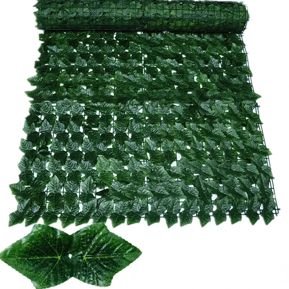 Green artificial ivy hedge fence panels showing dense foliage texture