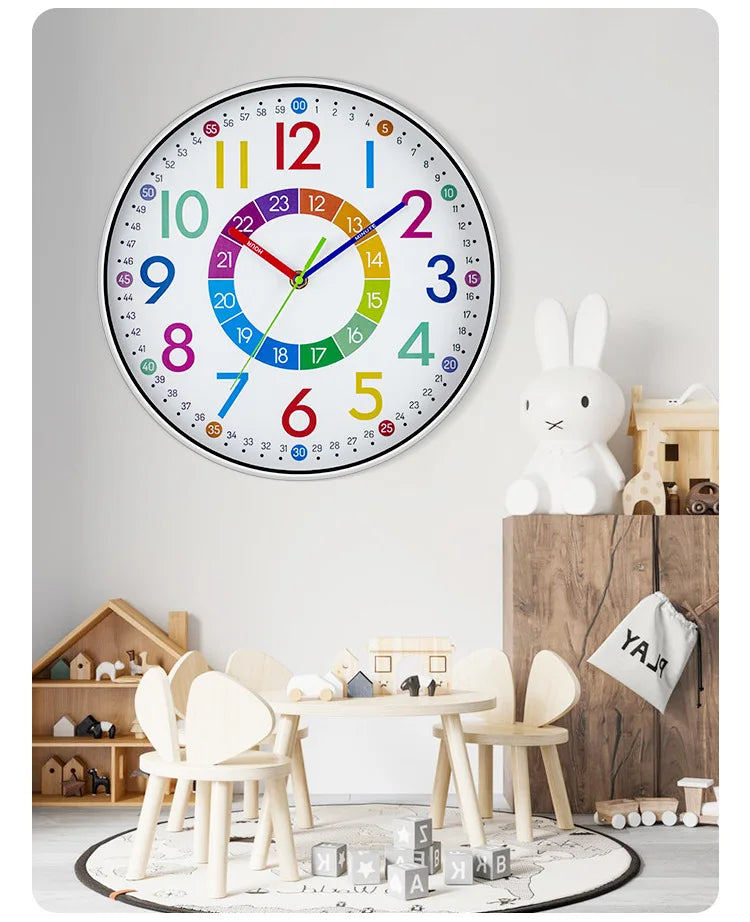 A colorful silent wall clock with numbers 1 to 12 and a decorative rabbit figurine on a wooden shelf.