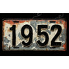 A vintage aluminum license plate tag with the year 1952, showing signs of wear and rust.