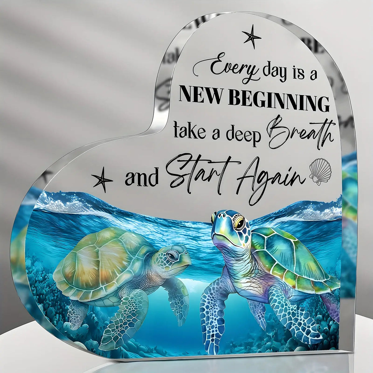 Acrylic tabletop decor featuring a blue sea turtle swimming underwater with text encouraging a new beginning.