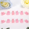 A collection of pink and light pink glow-in-the-dark mini pig figurines for creative decor.