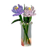 Hand-blown glass flower bouquet featuring purple and pink flowers in a clear mini vase