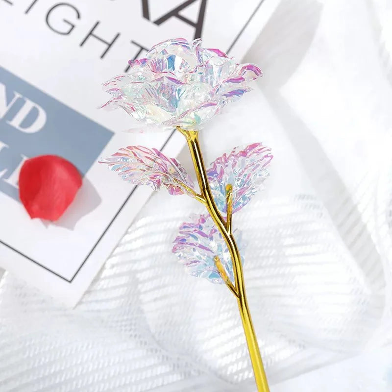 A delicate branch of rainbow artificial crystal flowers with iridescent petals on a gold stem.