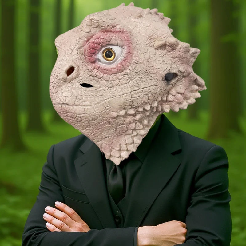 A realistic cute alien full-face latex mask with a textured, pale skin appearance and large yellow eye.
