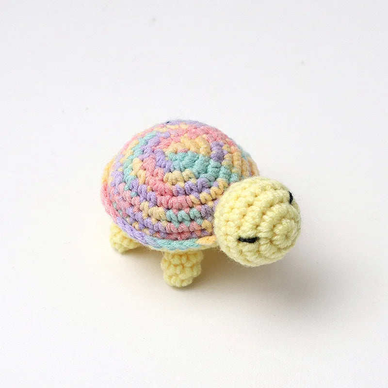 Handmade crocheted turtle plush with multicolored shell and yellow body