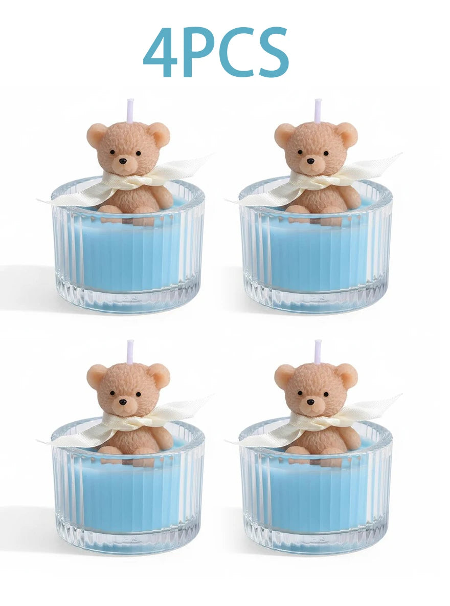 Four soy wax teddy bear candles in glass jars with white ribbon