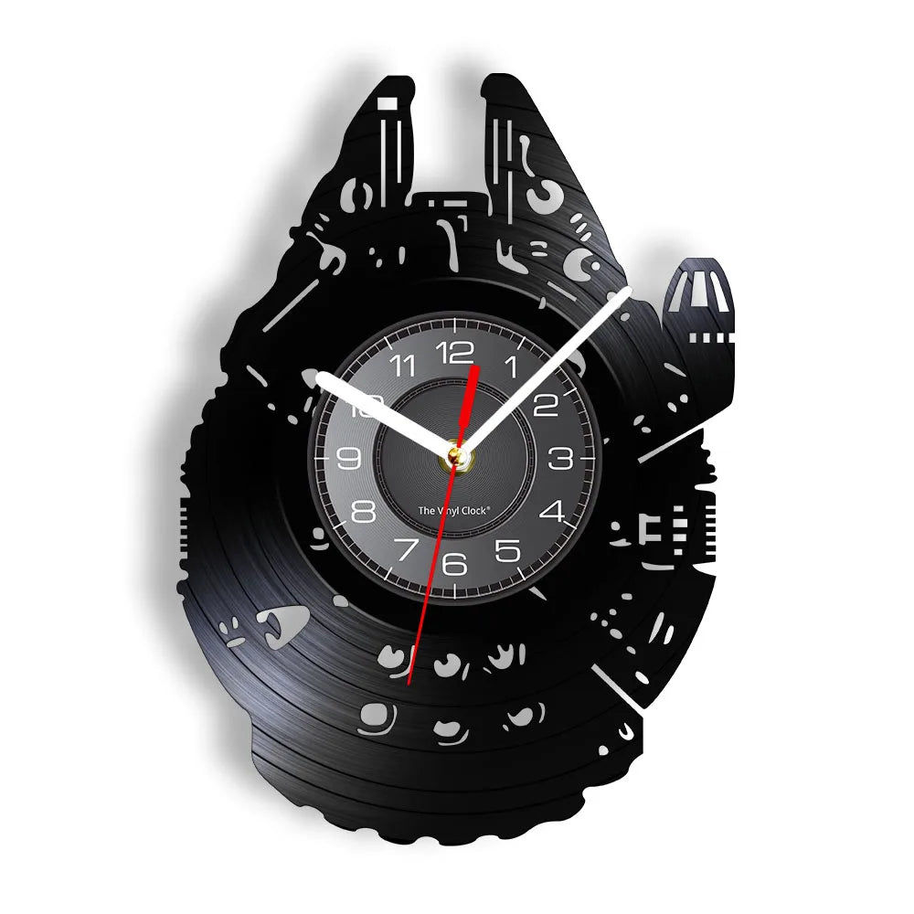 A black wall clock shaped like a Millennium Falcon vinyl record, featuring a clock face and decorative details.