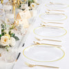 A set of hammered gold rim disposable dinner plates, silverware, and candle holders arranged on a white surface.