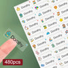 A close-up of custom waterproof name stickers featuring various cartoon characters and names for kids' belongings.