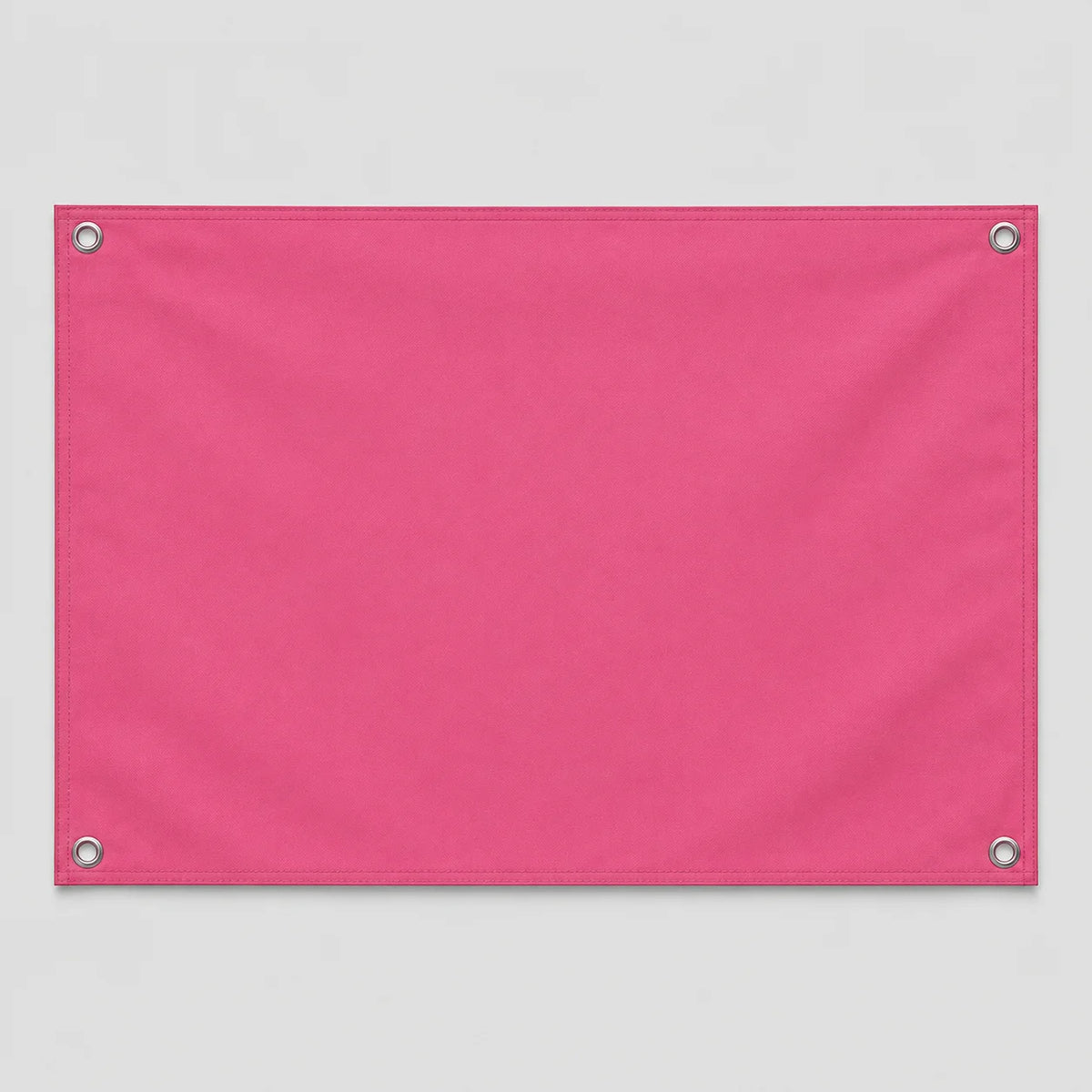 A rectangular pink fabric flag with grommets, ready for a custom photo design.