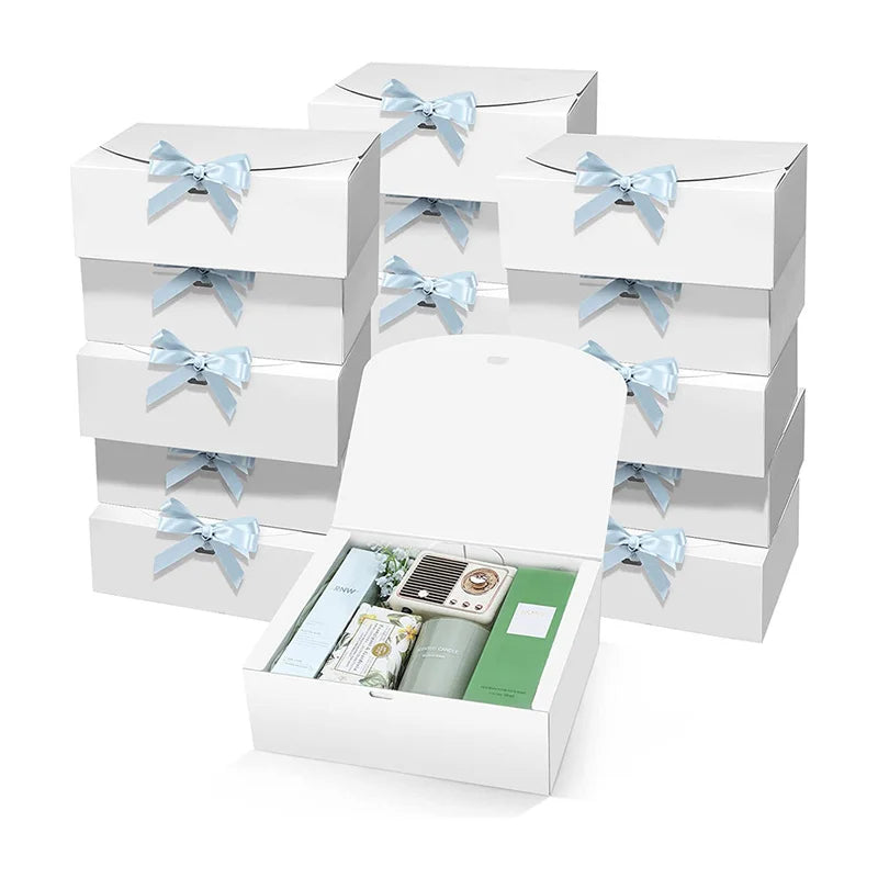 A stack of white kraft paper gift boxes tied with light blue ribbon bows.