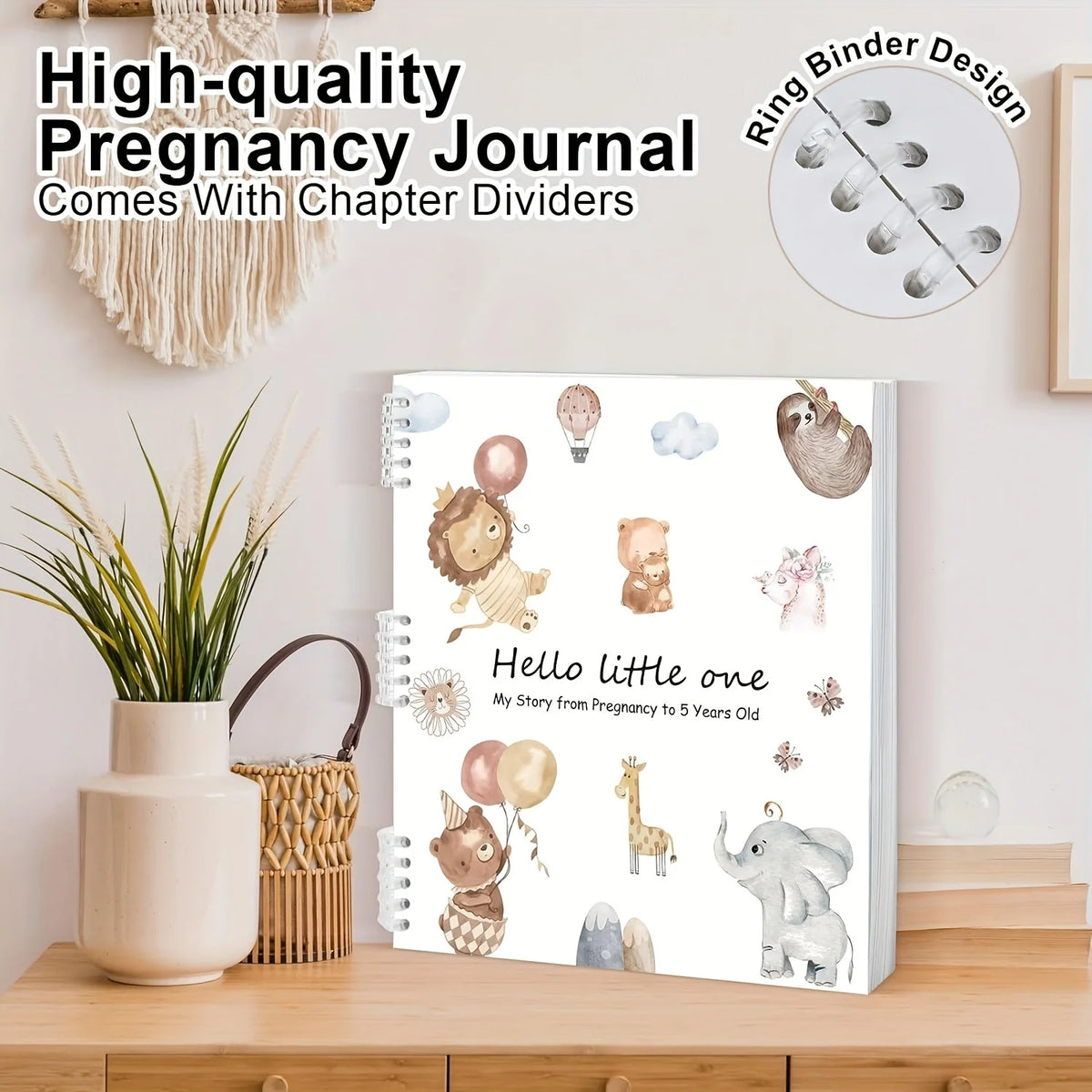 A spiral-bound pregnancy journal with chapter dividers and illustrations for baby memory keeping