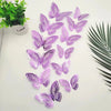 A collection of twelve purple and lilac 3D butterfly wall stickers arranged on a white surface.