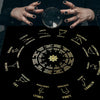 A dark velvet tablecloth featuring a pentagram tarot design with zodiac signs and planetary symbols.