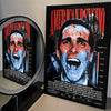A movie poster for American Psycho featuring Christian Bale's face with blood effects.