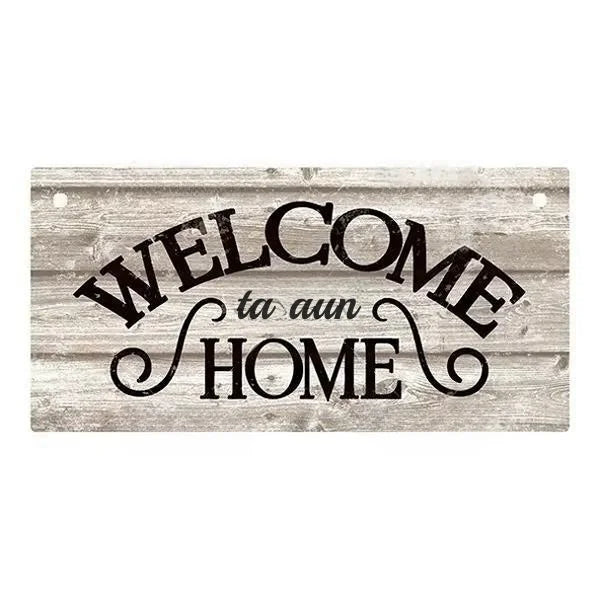 Rustic wooden hanging sign with black script that reads Welcome to our Home