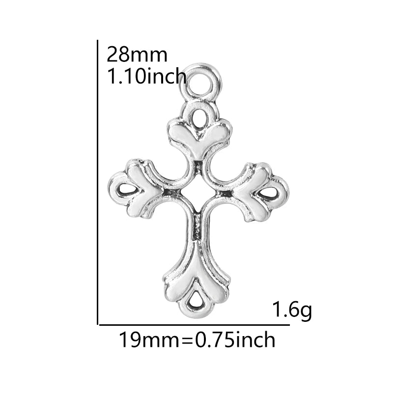 A silver antique cross charm measuring 28mm long and weighing 1.6 grams.