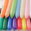 A collection of pastel colored magic twisting balloons in various shades including orange, green, blue, and pink.