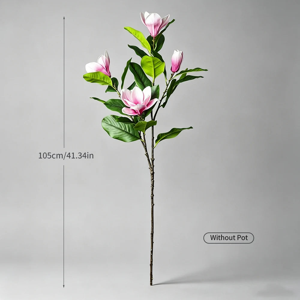 A tall artificial magnolia tree with pink silk flowers displayed against a gray background.