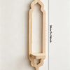 A light wood arch-shaped wall shelf with a decorative base and a small wooden shelf insert.