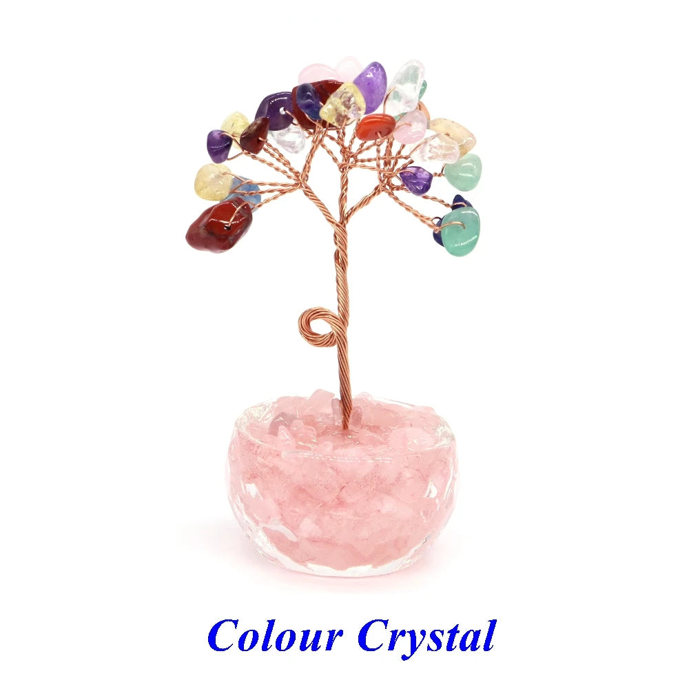 A crystal healing gemstone bonsai featuring various colored crystals growing from a pink quartz base.